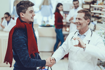 Pharmacist Handshaking with Customer