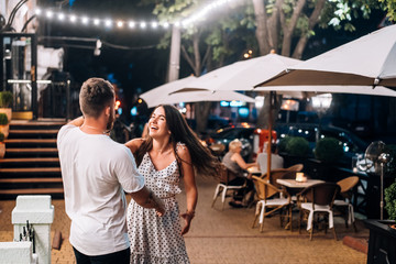 Young couple having fun at the summer restaurant.