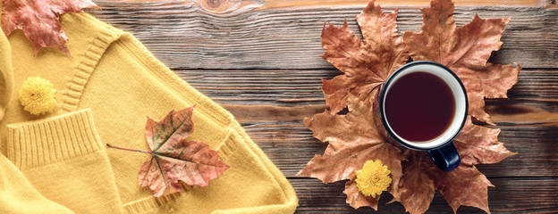 Autumn fashion seasonal concept sweater cardigan cup hot black tea