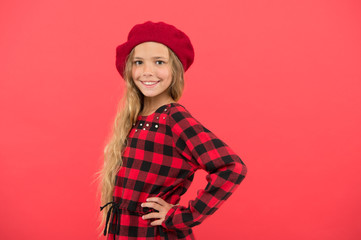 How to wear french beret. Beret style inspiration. How to wear beret like fashion girl. Kid little cute girl with long hair posing in hat red background. Fashionable beret accessory for female
