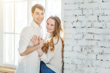 Romantic sexy couple in love having nice time together. Young woman hugging man, white light room background. Students, bride, groom, engagement, relationship, aspirations, supporting relying concept