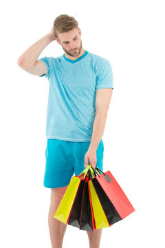 Shopping confusing him. Man handsome unshaved macho hold bunch shopping bags. Buy gifts concept. Guy shopping before holidays. Shopping discount sale season. Man carry paper bags with items