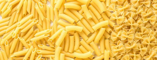 Types of Italian pasta penne rigatoni farfalle. Concept food background