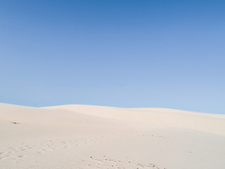Fototapeta na wymiar Amazing white dune, sand texture , blue sky pastel color, Brazil, Parnaíba. 