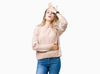 Beautiful young blonde woman wearing sweatershirt over isolated background surprised with hand on...