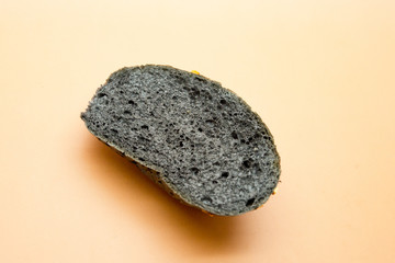 A piece of black bread on an orange background