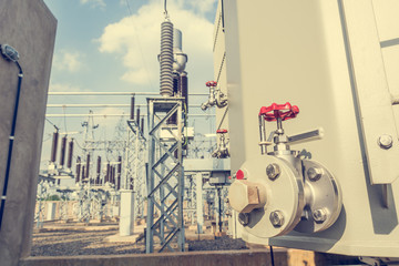 Detail and focus on red oil release valve of power transformer.