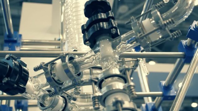 Laboratory equipment for vacuum distillation, glass flasks, tubes, coils and other equipment for the chemical industry. Shot in motion
