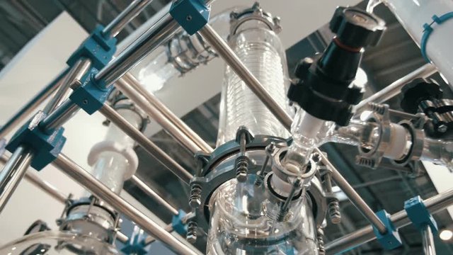Laboratory equipment for vacuum distillation, glass flasks, tubes, coils and other equipment for the chemical industry. Shot in motion
