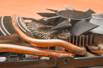 Dust on the computer pc processor cooler with mainboard and computer case fragment. Selective...
