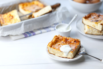 A piece of cottage cheese casserole with sour cream