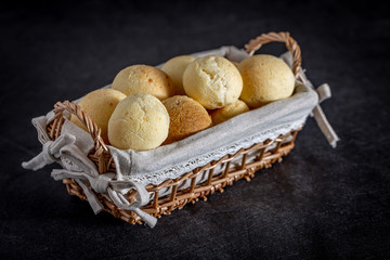 Brazilian homemade cheese bread, AKA 'pao de queijo' in a rustic basket.