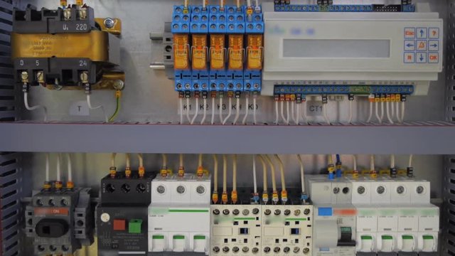 Electrical panel with multiple switches, wires, short circuit protection devices and electricity meter. Shot in motion