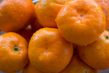 Close up of juicy wet orange citrus mandarins