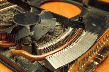 Dust on the computer pc processor cooler with mainboard and computer case fragment. Selective...