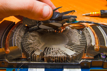 Dust on the computer pc processor cooler with mainboard and computer case fragment. Selective...
