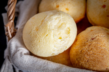 Brazilian homemade cheese bread, AKA 'pao de queijo' in a rustic basket.