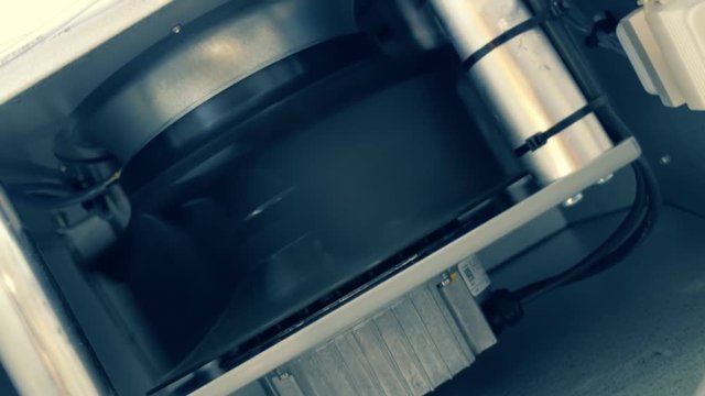 Industrial ventilation cooling equipment during operation. The impeller is moving the airflow. Shot in motion