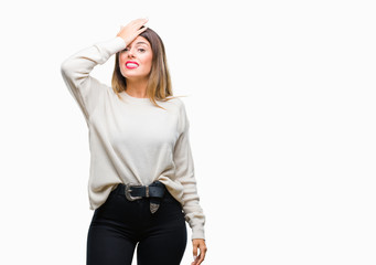 Young beautiful woman casual white sweater over isolated background surprised with hand on head for...