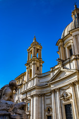 Obraz premium Closeup of the Rio de la Plata, in La Fontana Dei Quattro Fiumi designed by Gian Lorenzo Bernini, in Piazza Navona, Stadium of Domitian, in Rome, Italy. Church of Sant'Agnese in Agone in background