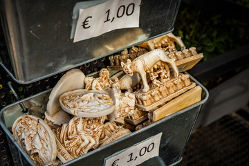 closeup of some souvenirs from Rome. Small objects that represent the Colosseum, Capitoline Wolf, Campidoglio, Bocca della Verità, Trevi Fountain, Castel Sant'Angelo, Piazza di Spagna, San Pietro