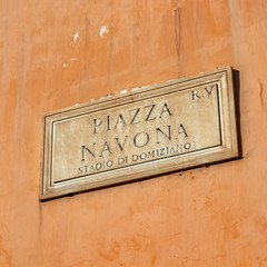 Street sign in Piazza Navona, Rome, Italy. Typical marble plaque of Rome, which indicates the name of the street or of the square, in the Italian capital. Navona square.