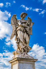 Obraz premium Angel with the scourges on the Ponte Sant'Angelo over the Tiber, at the Mausoleum of Roman Emperor Hadrian, usually known as Castel Sant'Angelo, in Rome, near the Vatican. Italy