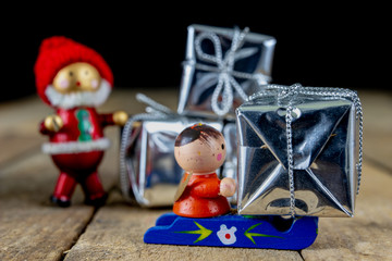 Christmas decorations on the kitchen table. Wooden Christmas figurines prepared for decorating a tree.