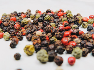 A mixture of pepper in the form of peas on a bright table