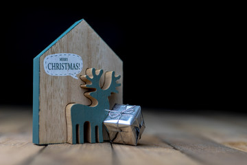 Christmas decorations on the kitchen table. Wooden Christmas figurines prepared for decorating a tree.