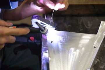 worker tig welding metal