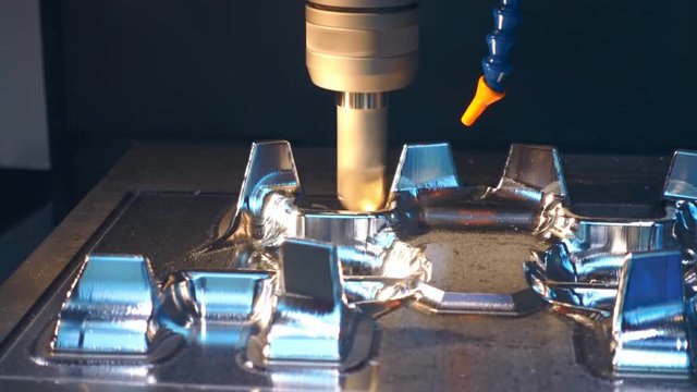 Milling machine carves detail under computer control. Shot in motion