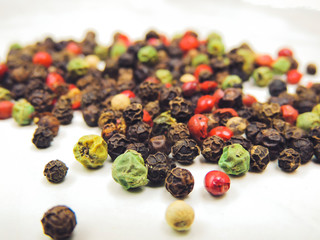 A mixture of pepper in the form of peas on a bright table