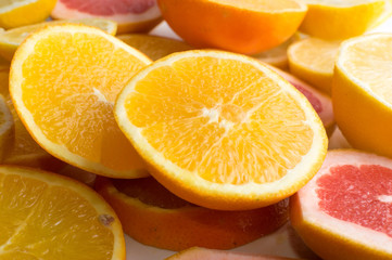 Fototapeta na wymiar Texture of sliced lemon, orange and red grapefruit