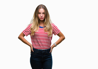 Young beautiful blonde woman over isolated background skeptic and nervous, frowning upset because of problem. Negative person.