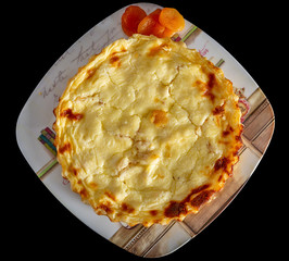 Homemade mini quiche with cheese and dried apricots isolated on black background.