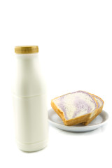 bottle of milk and sliced bread on white background