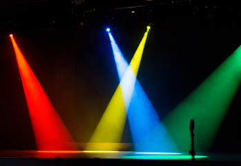 4 Colors spot lights shining through smoke on stage Red Yellow Blue Green