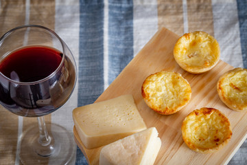 Homemade mini quiche with cheese on rustic background.
