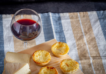 Homemade mini quiche with cheese on rustic background.
