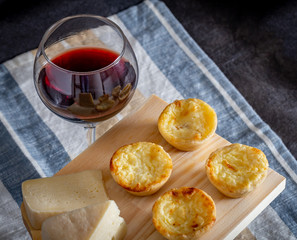 Homemade mini quiche with cheese on rustic background.