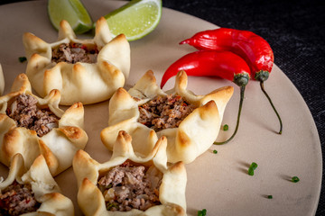 Arabian opened meat esfiha on rustic background.