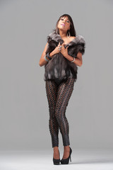 Young african-american woman wearing a fur jacket