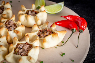 Arabian opened meat esfiha on rustic background.