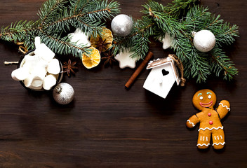 Christmas frame composition with cookies and fir tree branches   on wooden background. Holiday and celebration concept for postcard or invitation. Flat lay, Top view. Copy space