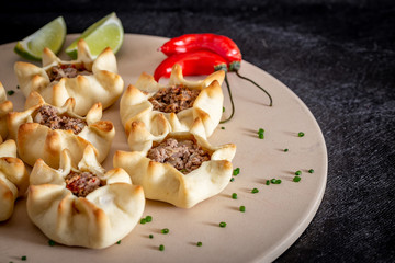 Arabian opened meat esfiha on rustic background.