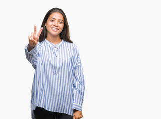 Young beautiful arab woman over isolated background smiling with happy face winking at the camera doing victory sign. Number two.