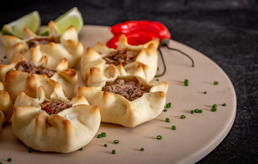 Arabian opened meat esfiha on rustic background.