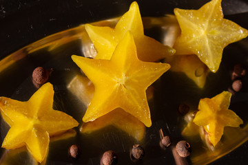 Star fruit at silver bowl with peppers