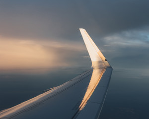wing of airplane with sunlight on winglet